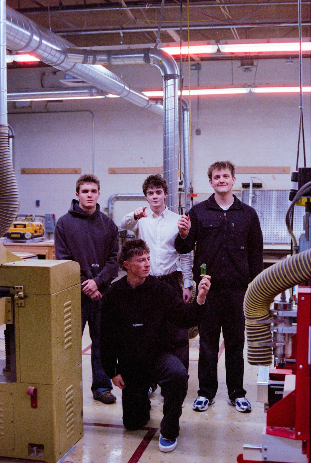 four-young-men-in-a-workshop-setting-dej3-qfbel4