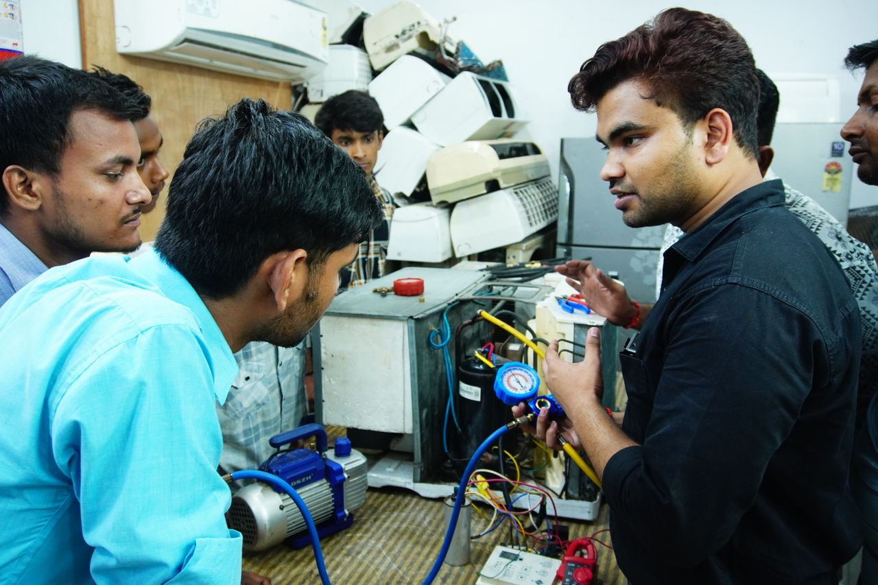about-img Participants learn AC repair during a hands-on session in Delhi, India.